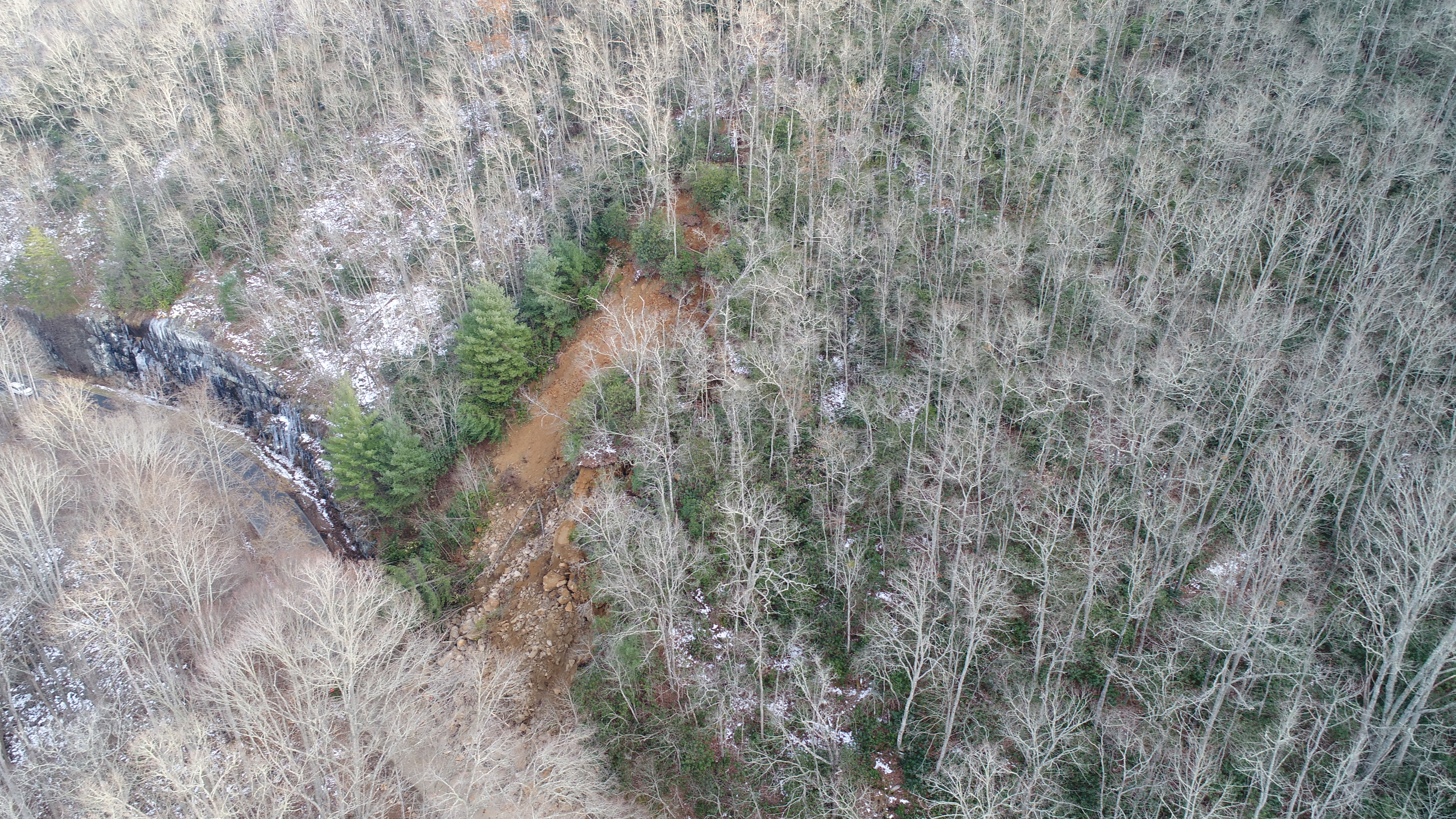 Aerial photograph showing a steep slope in western North Carolina with visible evidence of slope movement and landslide activity